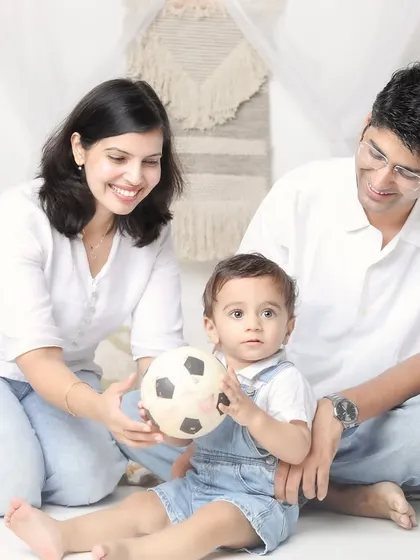 A playful moment with a soccer ball. Incorporating a simple prop can bring out your family's personality and create fun, interactive shots.