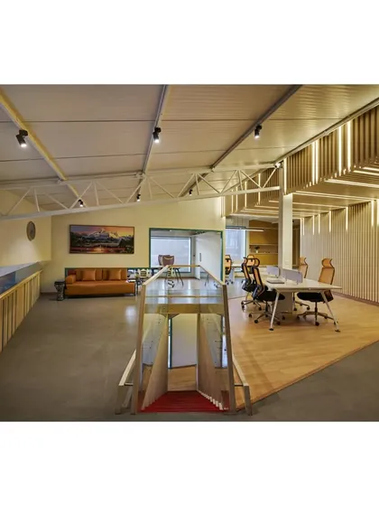 The interior of the Kadence Office, designed for a music company. The space is defined by striped, acoustically treated surfaces derived from graphic abstractions of soundwaves. The design creates different zones for creative work, meetings, and performances.