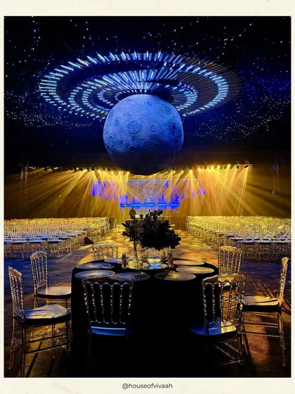 A sangeet night under a galaxy of our own making. We used a giant moon installation and dramatic lighting to transform this space into a celestial spectacle, creating an immersive, otherworldly experience for the celebration.
