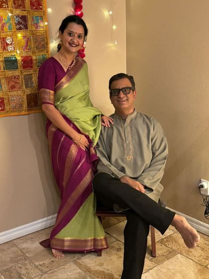 A beautiful couple celebrating, with the lady draped in a lovely green and purple pure Mysore crepe saree from my collection.