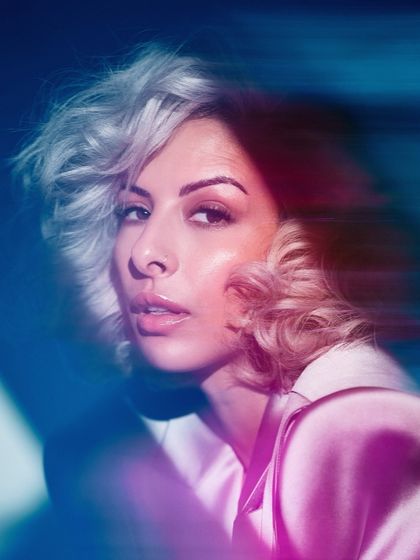 An artistic portrait with motion blur and colored lighting. Experimenting with visuals is key to finding your unique artist brand.