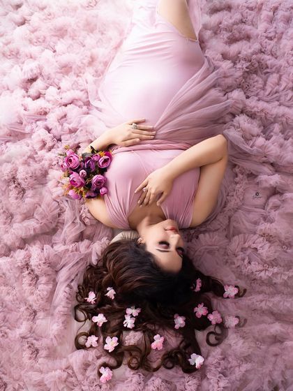 Another beautiful perspective of the 'bed of ruffles' setup. This overhead shot captures the peaceful expression of the mother-to-be in a truly unique and artistic way.