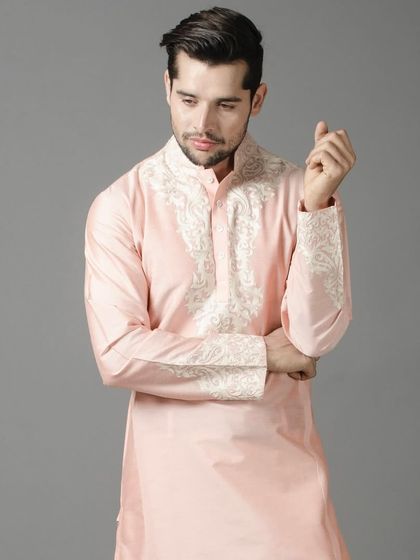 A beautiful pastel pink kurta with intricate white embroidery on the cuffs and placket. This piece offers a soft and romantic look, ideal for festive gatherings or a pre-wedding event.