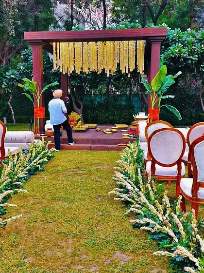 A view of the garden ceremony setup, showing our team member making final adjustments.