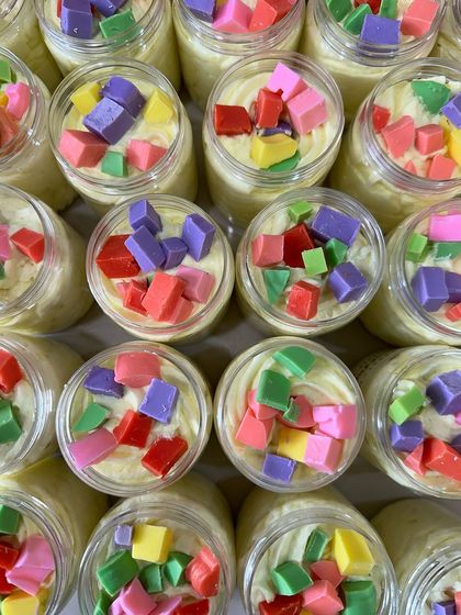 A vibrant array of my Tropical Paradise whipped soaps, ready to be sold. The colorful soap chunks on top make each jar a little piece of art.