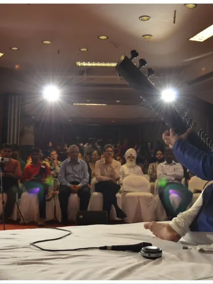 A dramatic shot from the stage at the India Habitat Centre, capturing the energy of a live concert.