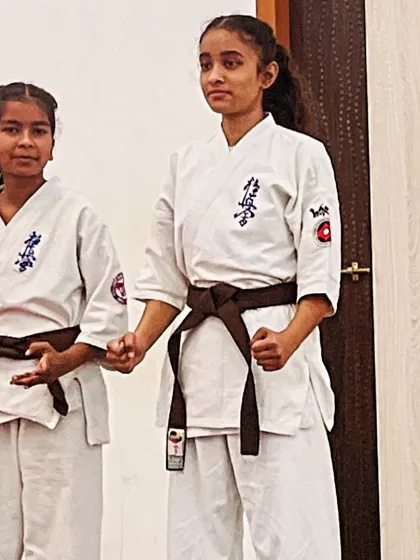 Two of my brown belt female students waiting for their turn to perform. The moments before competing are a test of mental calm.