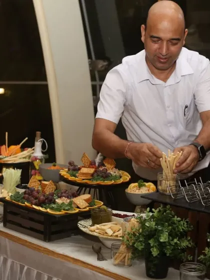 Here I am, arranging breadsticks on a beautiful buffet. We take pride in managing every aspect of the food display to create a seamless experience.