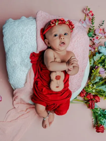 A curious little blossom. This three-month-old baby is awake and alert, taking in the beautiful floral world I created for them.
