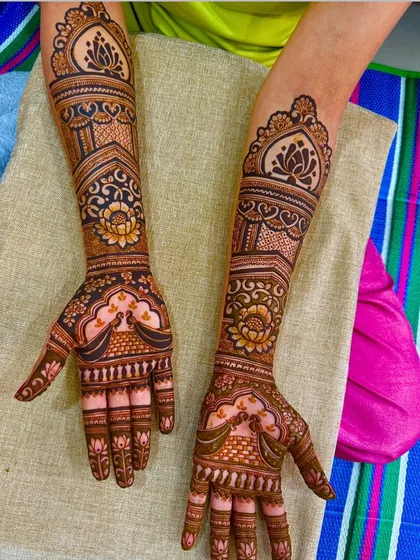 Another view of the peacock and lotus design, showing how it wraps around the arm. The patterns are consistent and flow beautifully from the palm to the elbow.