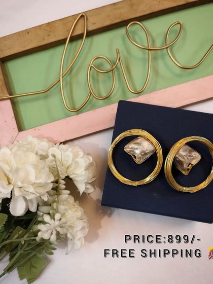 A beautiful flat-lay of the large brass and crystal hoop earrings, perfect for gifting.