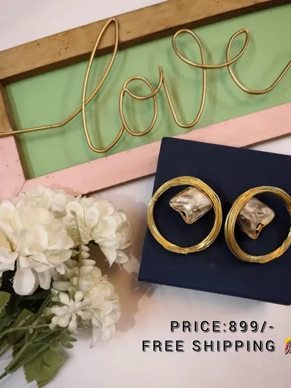 A beautiful flat-lay of the large brass and crystal hoop earrings, perfect for gifting.