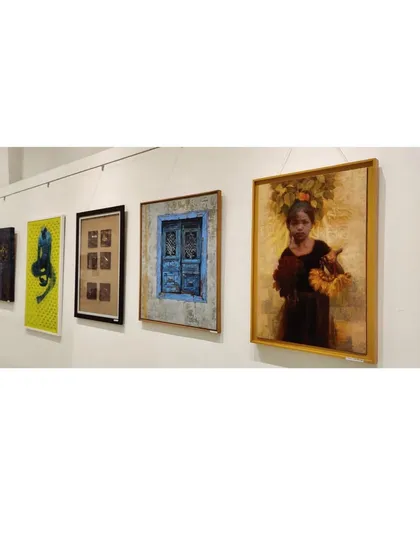 A view of the gallery wall at the Maharashtra State Art Exhibition, showing my painting among other works.