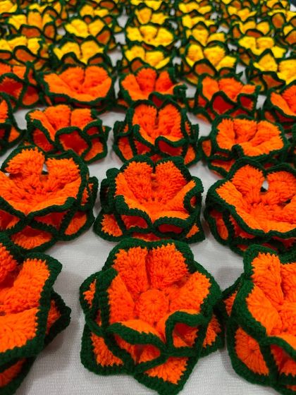 A close-up of the orange lotus coasters from the bulk order of 100. Each one is crafted with the same attention to detail, no matter the quantity.