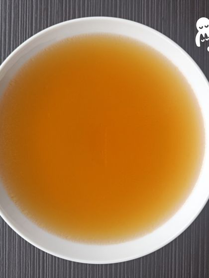 A bowl of our pure, clear bone broth. You can serve it warm or chilled. It's a simple, versatile supplement for both dogs and cats.