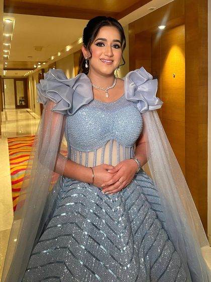 The full view of this pastel paradise look, showcasing the stunning gown and the glamorous makeup that completes the ensemble.