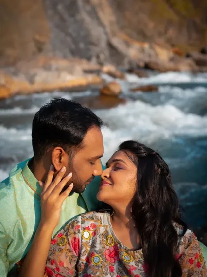 A gentle and intimate close-up of a couple sharing a moment by the water, showcasing their connection.