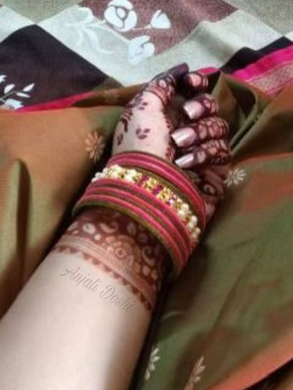 A "stain alert" photo showing the beautiful color development on the wrist and hand, complemented by traditional bangles.