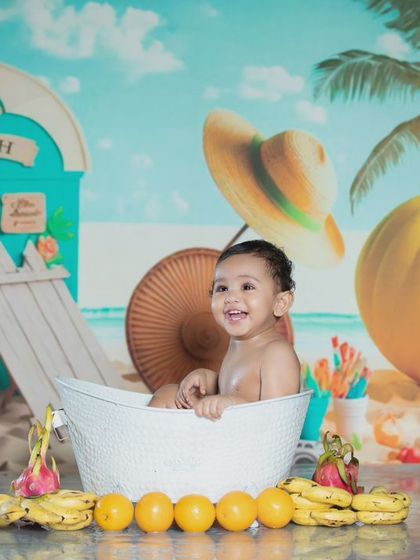 This little one is having a great time in his fruity beach bath.