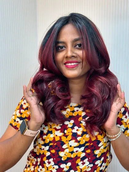 A happy client with her new cherry red balayage. The color is expertly blended for a funky yet sophisticated look.