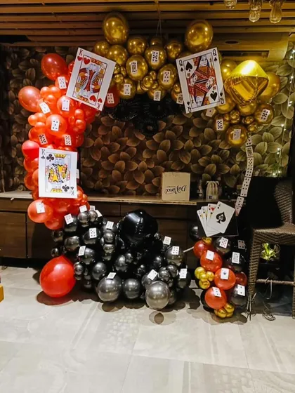 For a fun Diwali card party, I created this unique balloon arch. The design uses red, black, and gold balloons with oversized playing card cutouts. This kind of thematic decor is perfect for creating a memorable party atmosphere.