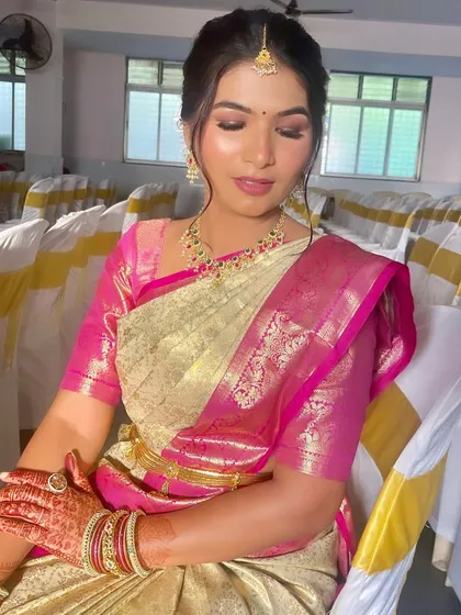 A close-up portrait showing the soft, glowing makeup and the traditional bindi and jewelry.