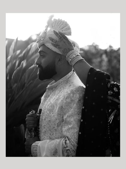A beautiful black and white shot of a mother's hand on her son's turban. This is a moment of blessing and love that I always look for.