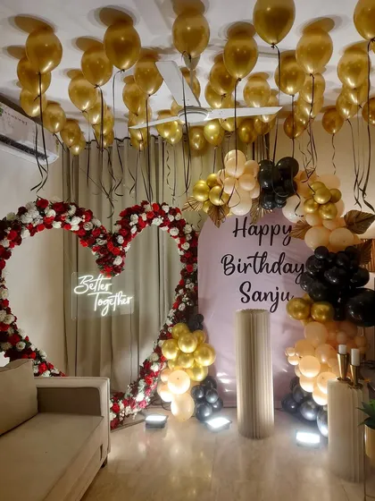 We combined a lush floral heart arch with a modern balloon garland for this grand birthday celebration. The 'Better Together' neon sign adds a personal touch, making it a great backdrop for both birthdays and anniversaries.