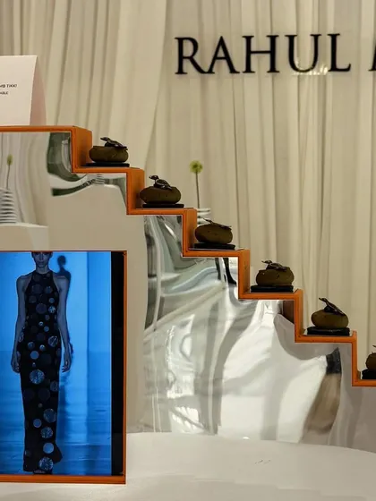 A tiered display of savory bites for the Rahul Mishra store launch, mirroring the architectural lines of the fashion on display. The presentation itself becomes part of the store's aesthetic.