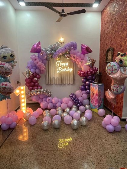 This is a duplicate of ID 5. A princess-themed birthday party with a modern twist. This setup features a circular balloon arch in shades of pink and purple, a neon 'Happy Birthday' sign, and a light-up marquee number '1'.