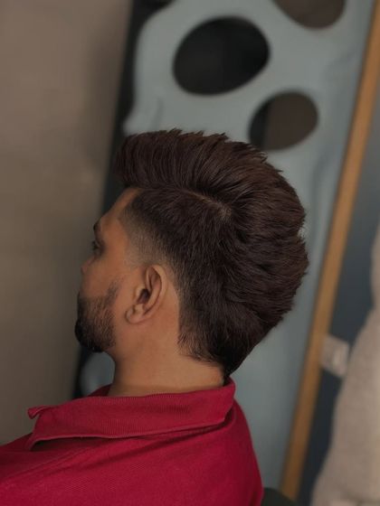 The burst fade. This style creates a cool semi-circle fade around the ear, and we styled the top with a lot of volume.