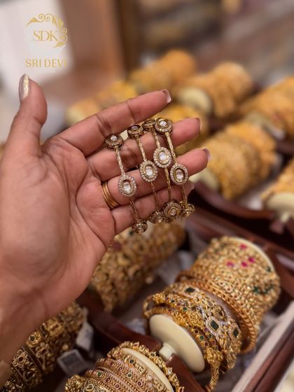 These delicate bangles feature a unique design with AD stones. They are lightweight and can be stacked with other bangles or worn on their own for a subtle look.