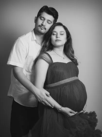 Lost in a moment of quiet reflection together. This black and white portrait captures the peaceful, serene side of waiting for a baby. Their closed eyes and gentle hold speak of a deep, soulful connection.