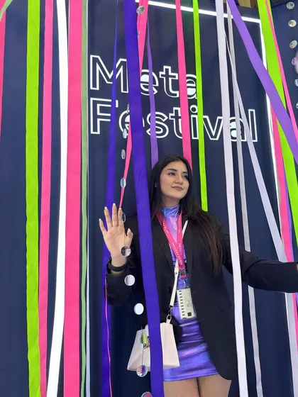 Waving from behind the colorful ribbons, a playful shot from the event.