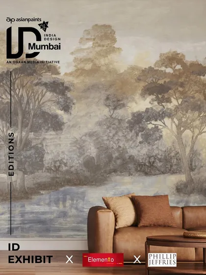 An atmospheric living room scene featuring a stunning, painterly landscape mural wallpaper from Phillip Jeffries. The soft, misty treescape creates a serene and expansive feel, demonstrating the transformative power of our large-scale wallcoverings.