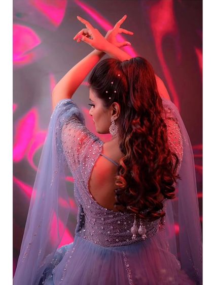 A beautiful pose showing the back of this powder blue gown. The open back and detailed hairstyle create a truly elegant and modern bridal look.