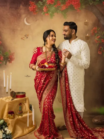 A joyful and romantic portrait from a Karva Chauth themed session. The couple's dance-like pose and happy expressions perfectly capture the celebratory mood of the festival.