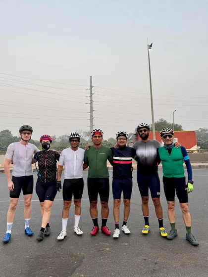 A group of seven riders, a mix of men and women, posing for a photo.