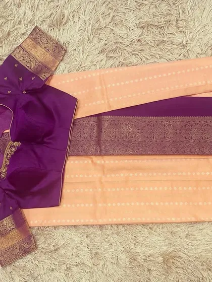 The front view of the violet blouse and peach saree, showing the simple elegance of the pairing.
