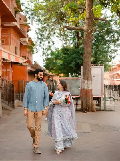 A candid walking shot of the couple smiling and talking as they stroll through the streets of Jaipur.