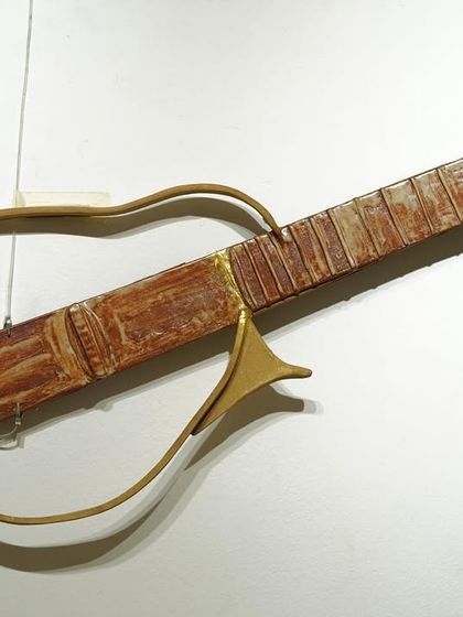 A unique commission, this is a ceramic sculpture of a guitar. It was a challenging and rewarding piece to construct, combining hand-building and carving techniques.