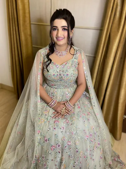 A smiling portrait of this engagement bride. Her pastel green gown is complemented by a soft glam makeup look with a touch of shimmer on the eyes.