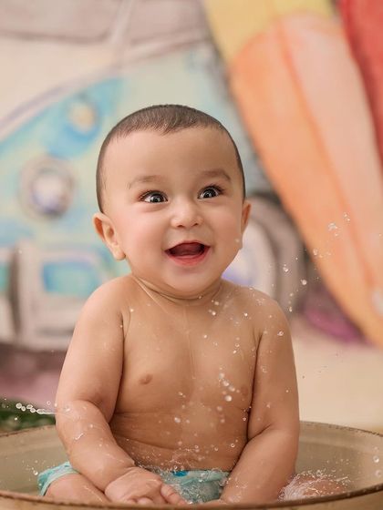 This little one is having a blast during his splash session. His wide-eyed, excited expression is what makes these photos so special.