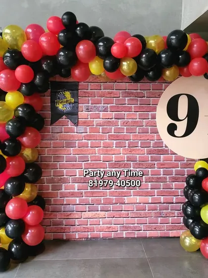 For all the magic fans, here is a Harry Potter themed decoration. It features a brick wall backdrop with the Platform 9 3/4 sign and a balloon arch in Gryffindor colors of red, black, and yellow.