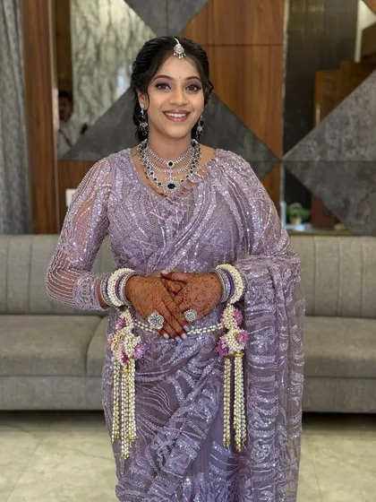 A smiling portrait of the happy mom-to-be. The soft glam makeup highlights her features without feeling heavy, ensuring she is comfortable throughout her event.