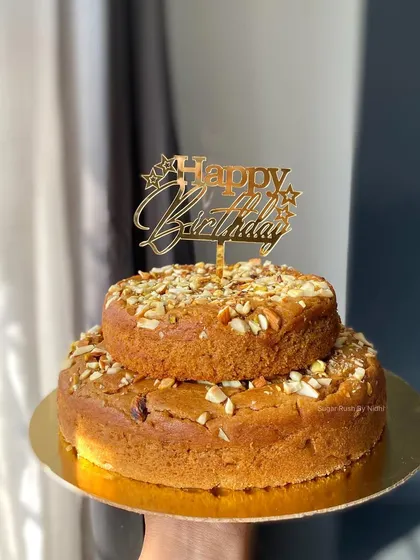 My healthy and delicious wholewheat jaggery tea cake, presented as a two-tier birthday cake. It's refined sugar-free but full of flavor.