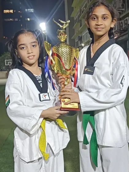 Two of our champions holding their trophy. Teamwork and mutual support are key to our success in competitions.