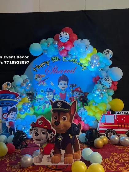A close-up of the Paw Patrol themed ring backdrop, showing the detailed character graphics and colorful balloon arrangement.
