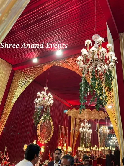 A view of the opulent ceiling decor, where chandeliers are paired with hanging mirrors and lush red draping for a truly royal feel.