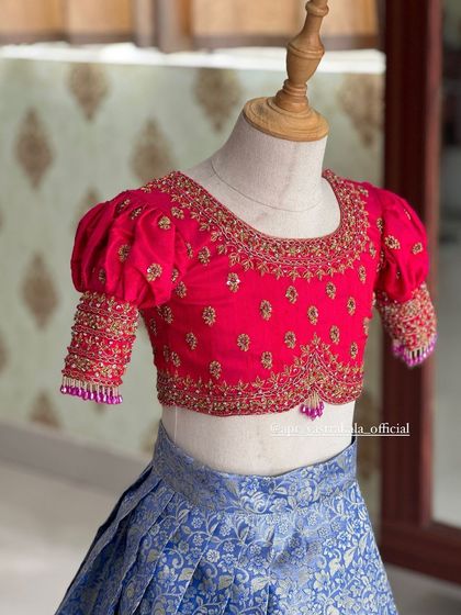 Another close-up of the pink blouse, showing the detailed embroidery on the neckline and sleeves.